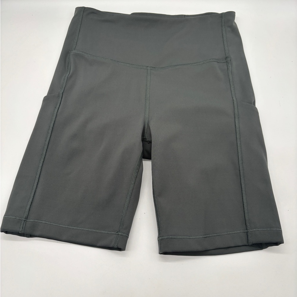 Athleta  Ultimate Stash II  7” Bike Shorts Pockets Olive Green Size XS